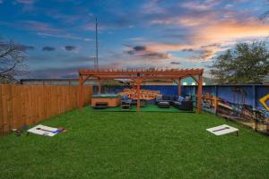 a backyard with a wooden gazebo with a pool table at Vibrant Vegas Vibes - Hot Tub & Games - Perfect 4 Family & Groups in Houston