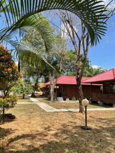 a house with a palm tree in front of it at Awandari Resort & Convention in Kangkakawal