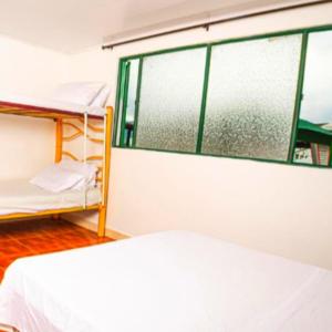 a room with two bunk beds and a window at La Esmeralda Entre las Montañas in Ibagué +19 photos