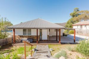 a home with a porch and a house at 46 Banjo Patterson Crescent in Jindabyne
