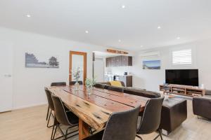 a dining room with a wooden table and chairs at 46 Banjo Patterson Crescent in Jindabyne