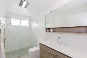 a bathroom with a toilet and a sink and a shower at 46 Banjo Patterson Crescent in Jindabyne +11 photos