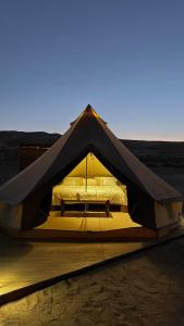 a bed in a tent in the desert at AYLA bidiyah in Badīyah +56 photos