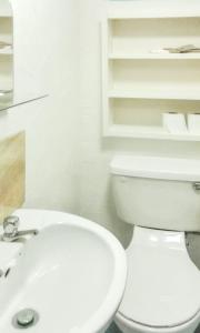 a bathroom with a white toilet and a sink at Cosy Apartment in Galway with Balcony, 32 m², City View in Galway