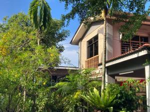 a house with trees in front of it at De Village Lodge in Balik Pulau +34 photos