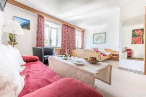 a living room with a couch and a table at Gasthof Einhorn Schaller in Schwaz