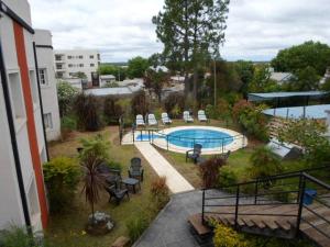 a view of a swimming pool in a yard at Hotel Queguay in Colón