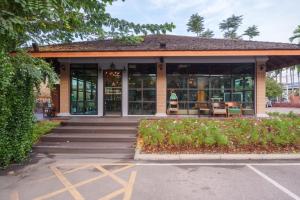 a building with a lot of windows and chairs at Khum Damnoen Resort in Ratchaburi