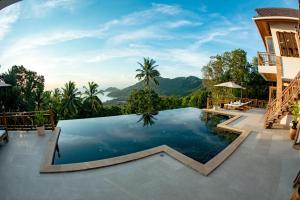 a pool at a resort with mountains in the background at Perfect View Pool Villa in Koh Tao
