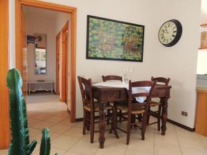 uma sala de jantar com mesa e cadeiras e um relógio em La Collina D'Oro em Cernobbio