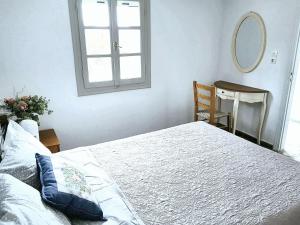 a bedroom with a large bed and a mirror at House with sea view in Porto Heli, fireplace and garden in Porto Heli