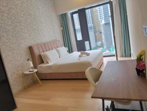 a hotel room with a bed and a table and a window at STAR Residences Popular By KLCC in Kuala Lumpur +108 photos