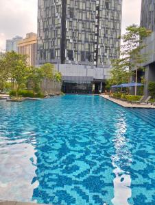 a large swimming pool in front of a tall building at STAR Residences Popular By KLCC in Kuala Lumpur