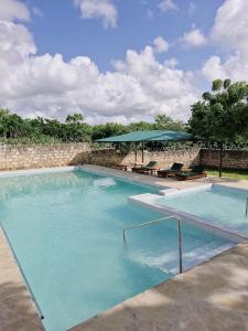 a large swimming pool with blue water at Jade luxury Apartments in Galu