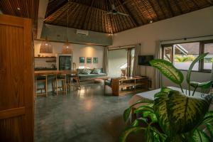 a living room with a couch and a table at Vassani Stay in Canggu