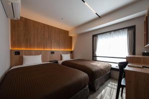 Postel nebo postele na pokoji v ubytování Belmont Hotel