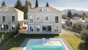 an aerial view of a house with a swimming pool at Zeta Luxury Villas in Mantoúkion