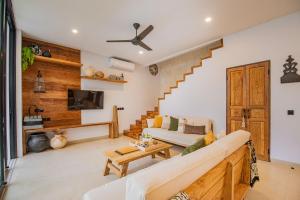 a living room with a couch and a table at Sister Suites in Seminyak