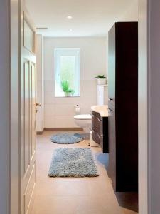 a bathroom with a toilet and a sink and a window at Grossenhain Ferien in Großenhain