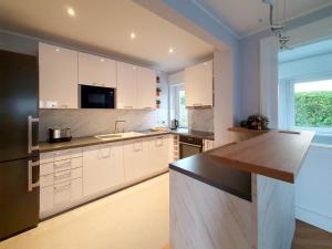 a kitchen with white cabinets and a counter top at Grossenhain Ferien in Großenhain