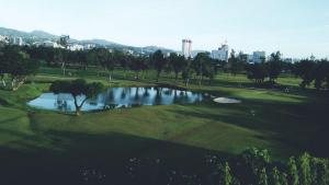 a view of a golf course with a pond at KLER Condo Resort Style at ONE Oasis in Cebu City