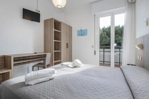 Postel nebo postele na pokoji v ubytování Hotel Astrid