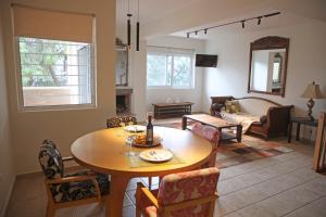 a living room with a table and a couch at Anavyssos Riviera Cozy Bee Home Maisonette in Anavyssos