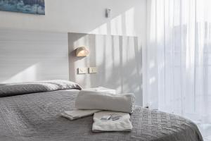 Postel nebo postele na pokoji v ubytování Hotel Astrid