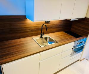 a kitchen with a sink and a wooden counter top at Brisa Vis Studio in Vis