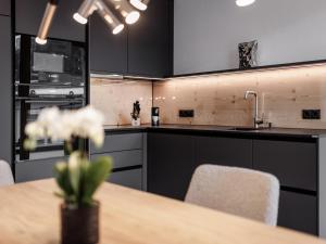 a kitchen with a table with chairs and a sink at Leni Mountain Lodge in Sölden