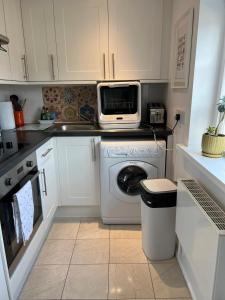 a kitchen with a washing machine and a microwave at Loft in Bungay in Bungay +32 photos