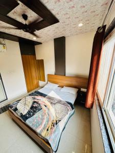 a bedroom with a large bed in a room at Hotel Green View in Ujjain +16 photos