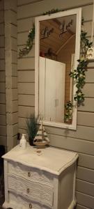 a mirror and a dresser in front of a house at Villa in Kalajoki