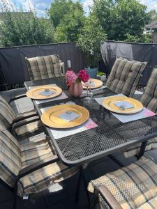 a patio table with plates and flowers on it at Lerchennest Nottuln in Nottuln