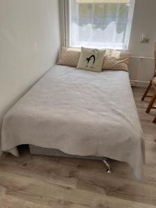 a bed with a pillow on top of it in a bedroom at Rene Stay Naisiai in Naisiai +3 photos