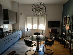a kitchen with a table and chairs and a chandelier at the apARTment in Lanciano
