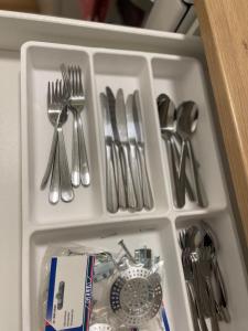 un tiroir rempli d'ustensiles en argent et d'une montre dans l'établissement Quiet and peaceful apartment, close to everything, à Tromsø