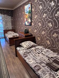 a bedroom with two beds and a wall mural at Отель біля озера in Mukacheve