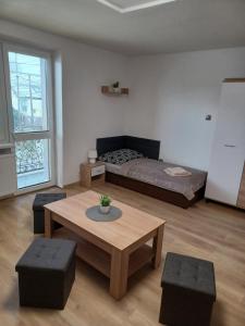 a living room with a bed and a table at U Poličky in Banská Bystrica