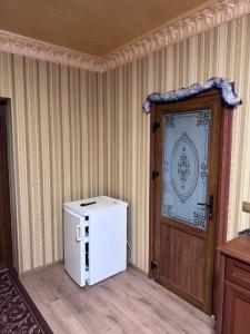 a small refrigerator in a room next to a door at Отель біля озера in Mukacheve +44 photos