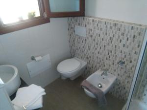 a small bathroom with a toilet and a sink at Casa Marina Maria in Murta Maria +114 photos