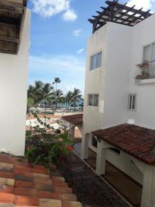 a building with a bench in front of a beach at Lovely apartment by the Caribbean in Bayahibe
