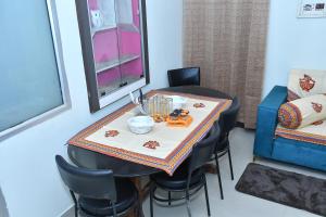 a dining room with a table with chairs and a tableablish at Happy Home in Jaipur