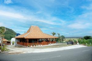 a building with a roof on the side of the road at The Swantari by ARBA in Kenteng