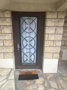a door to a house with a hello sign on it at studio in Tremblay-En-France