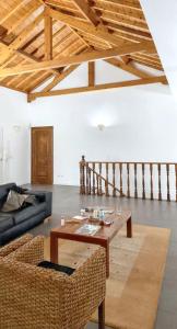 a living room with a table and a couch at Spacious House with Sea View in Angra do Heroísmo in Angra do Heroísmo