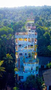 a large white building with plants on it at The Hotel Ujaliya in Ratgama Hegoda +26 photos