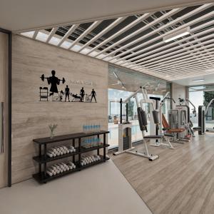 a gym with a wall with a poster of a man exercising at Radisson Hotel Jeddah Tahlia in Jeddah