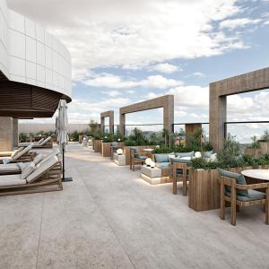 a patio with couches and tables and chairs at Radisson Hotel Jeddah Tahlia in Jeddah