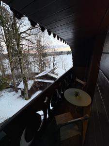 a room with a table and a view of a snow covered window at Maison d hotes villa les pervenches in La Chaux-de-Fonds